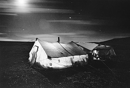 Barbara Van Cleve - Moon and Star Tracks Over Cook Tent - Silver Gelatin Photograph - 13 x 19 1/2 inches - Artist Statement: <br> <br>Although I use photography as a tool for capturing images, I know it must also be a means of revealing and sharing compassion for, love of, hope for, dreams of, information about, and the resonating memories of the “thing observed.” All vision, which includes photographic vision, has a spiritual content. I believe passionately that this kind of vision honors the single moments of human existence, which I try to communicate. Like a sunset or a snowflake, no two moments of life are the same. Photography is a great gift to me, and one that comes with equally as much responsibility.