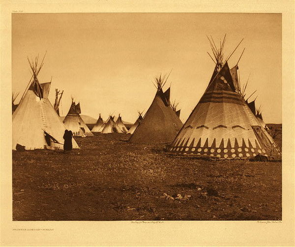 Edward S. Curtis - Plate 186 Painted Lodges - Piegan - Vintage Photogravure - Portfolio, 18 x 22 inches - <br>Taken by artist Edward S. Curtis, this beautiful Piegan scene depicts a large camp of tipis in which a few have been painted. Known to have some of the larges tipis of the plains Indians, Piegan often painted their lodges. The imagery could display the owner’s career, life as a warrior, or something seen in a vision. Most likely the tipi seen here is an imitation of a tipi seen in a vision. <br> <br>This image was taken by Edward S. Curtis in 1900, around the very beginning of his project The North American Indian. It was printed on Dutch Van Gelder paper and is currently for sale in our Aspen Art Gallery. Another great example of a painted tipi is Edward S. Curtis photo, “Plate 141 Apsaroke Medicine Tipi” which you can find on our website.