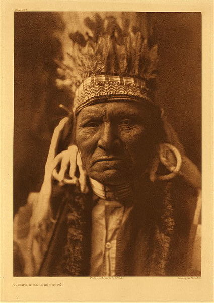 Edward S. Curtis - Plate 257 Yellow Bull - Nez Perce - Vintage Photogravure - Portfolio, 22 x 18 inches - As a member of the family which was more than once responsible for precipitating the Nez Perce outbreak of 1877, Yellow Bull proved a source of much valuable information. His son Walaituts was one of the three men who murdered the first white settlers in this conflict.” - Edward Curtis <br> <br>During the onset of this event, Chief Joseph and the other proponents of peace were not in the Nez Perce camp at the onset of this event. Had the peacemaker been, he may have been able to quell the hot-headed youth. As the genesis of the Uprising in 1877, a young Indian, Walaituts was goaded by others into the retribution for the murder of his father by one of the local settlers. In their revenge they killed three. When the news reached the camp, the men knew there would be consequences and the outbreak then escalated. <br> <br>Yellow Bull is an important figure in the effort to bring a peaceful outcome to the settlement of the Nez Perce and was photographed at the funeral of Chief Joseph, wearing the headdress of his good friend. That was 1904, one year after the portraits of these two friends were taken by Edward Curtis.