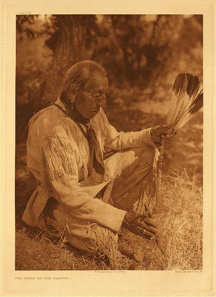 Edward S. Curtis - *50% OFF OPPORTUNITY* Plate 658 The Story of the Washita - Vintage Photogravure - Portfolio, 22 x 18 inches - In this Edward Curtis photo an elderly Cheyenne warrior remembers the famous yet devastating battle of the Washita in 1865. The battle was led by General Custer who was hoping to restore his reputation. He was so desperate to make an attack that he did not identify the camp or do any research into who they were. This lack of information led him to attack a peaceful Cheyenne tribe on reservation soil where they were promised safety by the US. The reservation was just outside Cheyenne Oklahoma. <br> <br>Custer ended up killing 103 people including women and children. It was spun to look good for Custer and was seen as a victory for the US. The Cheyenne however were not pleased, and one could surmise that the hatred he caused that day may have led to his death in the Battle of Little Bighorn. <br> <br>This image was printed by Edward S. Curtis in 1927 on Dutch Van Gelder paper. It is now available for sale in our Aspen Art Gallery.