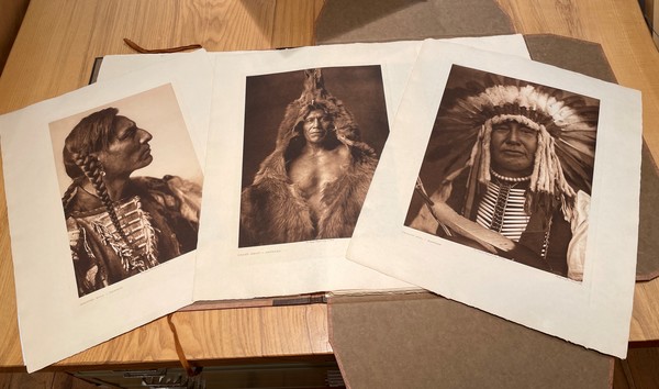 Edward S. Curtis - Complete Portfolio V - Portfolio, 22 x 18 inches - This complete portfolio consists of 36 large-format hand-pressed photogravures, paper type: Japon Vellum, with original title page list, and an original large folio case: The images were loose as issued in the original brown ¾ morocco portfolio with flaps and ties. <br> <br>“The North American Indian” took 16 years longer to complete than projected, and exceeded its budget by nearly $1.4 million. A complete set is valued at $1.8 to $2.6 today. Curtis’ project won support from such prominent and powerful figures as President Theodore Roosevelt and J. P. Morgan. <br> <br>Curtis’ work stands a monumental photo-ethnographic publishing project and an unrivaled masterpiece of visual anthropology. His images remain indelible in the American consciousness.