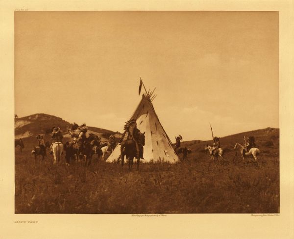 Edward S. Curtis - Plate 093 Sioux Camp - Vintage Photogravure - Portfolio, 18 x 22 inches - It was customary for a war-party to ride in circles about the tipi of their chief before starting on a raid into the country of the enemy.