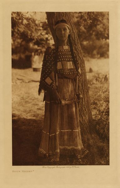 Edward S. Curtis - Sioux Maiden - Vintage Photogravure - Volume, 12.5 x 9.5 inches - "The decorative art of the Lakota found expression on their deerskin garments, pipe-bags, saddle-blankets, robes, parfleches, shields and tipis... There seems to be no fixed motif in many of their designs, each woman reading into her art whatever may be prompted by her thoughts, the same figure sometimes meaning as many different things as there are workers." from "The North American Indian" by Edward S. Curtis, Volume III