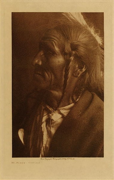 Edward S. Curtis - *50% OFF OPPORTUNITY* No Flesh - Ogalala - Vintage Photogravure - Volume, 12.5 x 9.5 inches - Pictured in this image by Edward S. Curtis is No Flesh of the Ogalala tribe. While he is pictured as if he is perhaps a man of importance, we know almost nothing about him. Edward Curtis took this photograph while he was discovering the Teton Sioux for his third volume of the North American Indian. <br> <br> This photogravure was taken in 1907 by Edward S. Curtis. The piece was printed on Dutch Van Gelder and is available for sale in out Aspen Art Gallery. <br> <br>Provenance: Original Subscription Set #59. George D. Barron, Rye, NY