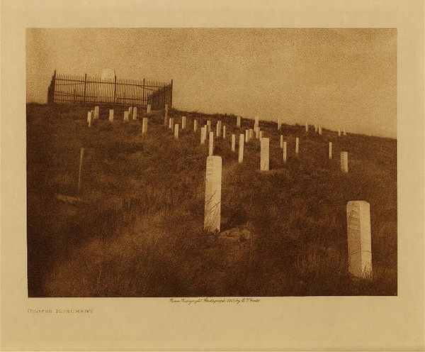 Edward S. Curtis - Custer Monument - Vintage Photogravure - Volume, 9.5 x 12.5 inches - After the Custer battle Congress as well as the military authorities awakened to the seriousness of conditions among the Lakota. On August 15, 1876, an act was passed for the appointment of a new commission, and on August 24, the personnel was made up as follows: George W. Manypenny, Henry C. Bullis, Newton Edmunds, Bishop Henry B. Whipple, A.G. Boone, A.S. Gaylord, General H.H. Sibley, and Dr. J.W. Daniels. They prepared a treaty in advance, the main object was to secure the cession of the Black Hills. Many concessions and advantages were promised and an effort was to be made to move the Lakota into Indian Territory. In violation of the Laramie treaty of 1868, no effort was made to obtain the consent of three-fourths of the adult males; but instead the treaty was first presented to the friendly Spotted Tail and his leaders, and then to the headman of the other bands separately. By the end of October all of the Lakota except the irreconcilable bands of Gall and Sitting Bull had signed. The Indian Territory project was abandoned, and after discussing other localities without results the bands settled down to a prosaic existence on the reservations where their survivors are still living. <br> <br>Provenance: <br>Art Institute of Chicago, Ryerson & Burnham Library