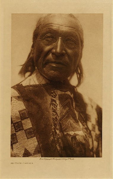 Edward S. Curtis - *50% OFF OPPORTUNITY* He Crow - Ogalala - Vintage Photogravure - Volume, 12.5 x 9.5 inches - There were five principal religious rites "Sun Dance," "Vision Cry," Ghost Keeper," "Buffalo Chant" (puberty), and "Foster-parent Chant." All were intoned by a mythical person, "Pte-sa-wi ya," "White Buffalo Woman." The dances of the societies had no religious significance, and there was no ritualistic healing ceremony. <br> <br>Provenance: <br>Art Institute of Chicago, Ryerson & Burnham Library