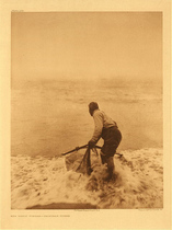 Edward S. Curtis - *50% OFF OPPORTUNITY* Plate 469  The Smelt Fisher-Trinidad Yurok - Vintage Photogravure - Portfolio, 22 x 18 inches - A Yurok man throws his net into the incoming waves with the intention of catching smelt to eat. The ocean in the background is foggy and fades into nothingness so that the entire focus in on the fisherman. His dress looks modern, pants and a shirt and his hair is cut short. The Yoruk tribe was often on the coast of what is now California. 
<br>
<br>“The surf-net used in smelt-fishing is a bag suspended on two diverging poles. At the bottom of the net proper is a restricted opening into a long net-bag, which is held in the fisherman's hand. Dipping and raising his net, he allows the imprisoned smelts to fall down into the bag, where they are securely held until he has enough to justify him in going ashore to empty it.” - Edward Curtis