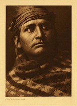Edward S. Curtis - Plate 026   A Chief of the Desert - Navaho - Vintage Photogravure - Portfolio, 22 x 18 inches - From Edward Curtis' North American Indian: This stunning image was described as: Picturing not only the individual but a characteristic member of the tribe - disdainful, energetic, and self-reliant. 
<br>
<br>The North American Indian Portfolio's that this piece came out of pictured and described in unprecedented detail the Native Americans of the Western United States and Alaska. The volumes include some 1511 hand-printed illustrations (including 1505 photogravures, four maps, and two diagrams), as well as over 3000 pages of text and translations of languages and music.
<br>
<br>Many of these images are on display in our Aspen Art Gallery.