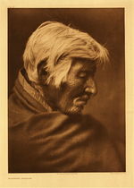 Edward S. Curtis - Plate 226 Klickitat Profile - Vintage Photogravure - Portfolio: 22 x 18 inches - Printed by photographer Edward S. Curtis in 1910, this image displays a profile of a Klickitat man. Wearing what is probably breech cloth which was the typical dress until they adopted the plains Indians style of dress. The Klickitat were located in southern Washington. This piece is printed on Deluxe Japanese Tissue and is available for sale in our Aspen Art Gallery.