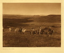 Edward S. Curtis - Plate 169 The Land of the Atsina - Vintage Photogravure - Portfolio, 18 x 22 inches - Edward S. Curtis documented the Atsina’s in his portfolio and volume five for the North American Indian project. This image called, “The Land of the Atsina” show a procession of riders crossing Atsina Land. The Atsina would have been located in Montana and migrated between the Missouri and Askaw rivers. 
<br>
<br>This image was taken in 1908 and printed on Japon Vellum. It is available for sale in our Aspen Art Gallery.