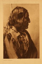 Edward S. Curtis -   Plate 219 Little Wolf - Cheyenne - Vintage Photogravure - Portfolio, 22 x 18 inches - This photograph was taken by Edward S. Curtis in 1905 for portfolio VI of his North American Indian project. Edward Curtis was about 5 years in to what would become a 30 year undertaking in documenting the Native American Indians. Pictured here is an elderly man named Little wolf. He is pictured in profile in traditional Cheyenne dress. Cheyenne men would generally wear hip leggings of deerskin or buffalo and deerskin shirts. The tribe was located around Minnesota and North Dakota, they were nomadic and migrated from the upper Mississippi river area in Minnesota to the Cheyenne River in North Dakota.
<br>
<br>This Edward S. Curtis photograph was printed on Japon Vellum and is available for sale in our Aspen art Gallery.