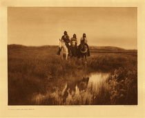 Edward S. Curtis - Plate 095 In the Land of the Sioux, 1905 - Vintage Photogravure - Portfolio, 18 x 22 inches - This Edward S. Curtis photograph depicts 3 Sioux Indians on horseback. They appear to be looking off to the right and are shown in typical Sioux landscape which could be anywhere in North or South Dakota or Montana. The land is characterized by broad rolling prairie and low hills. The figures are reflected in a buffalo-wallow a feature often seen in Sioux landscape. A buffalo wallow is a natural depression in the land that collects rainwater and runoff. In the time of the Sioux buffalo-wallows would serve as watering holes for wildlife, including the American bison.
<br>
<br>The three pictured here by Edward S. Curtis in the Badlands were Red Hawk, Crazy Thunder and Holy Skin all Ogalala Indians. This image was taken around 1905 and was printed on Dutch Van Gelder. The photogravure is currently for sale in our Edward S Curtis Gallery located in Aspen, Colorado.