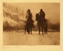 Edward S. Curtis - Plate 129 For A Winter Campaign - Vintage Photogravure - Portfolio, 18 x 22 inches - It was not uncommon for Apsaroke war-parties, mounted or afoot, to move against the enemy in the depth of winter. See Volume IV, page 105, for the narrative of such an expedition. The warrior at the left wears the hooded overcoat of heavy blanket material that was generally adopted by the Apsaroke after the arrival of traders among them. The picture was made in a narrow valley among the Pryor mountains, Montana. - Edward Curtis
<br>
<br>In a short distance offensive, they would have traveled by horseback, but a long distance trek changed to travel on foot. A tale of a campaign against the Lakota and Cheyenne in winter gives us further idea as to how they travelled eleven days toward that confrontation.
<br>
<br>“A crier was sent to alert warriors to prepare for the winter expedition. With only one horse per warrior, and many days of travel, each brought only the clothes on their backs, extra moccasins, firearms and food. Most horses were not ridden, but herded, so as to keep them fresh for the battle. This left them to walk through midwinter snow in Montana.”