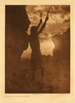 Edward S. Curtis - Plate 592 Offering to the Sun - San Ildefonso - Vintage Photogravure - Portfolio, 22 x 18 inches - Two ceremonially significant days were the winter and summer solstices. The midwinter prayer to the sun is the opportunity for the War Chief to give a message to the people.
<br>
<br>The prayer of the War Chief extended beyond himself when he goes out and passes from place to place, offering meal and praying. Also, at this time he calls aloud at several places, arousing the sleepers: “My dear people of the pueblo, I wish you to get up. Let all be thankful that a new day comes. Let us pray for good health and good luck and long life. Let all pray to the east. For I am the war-chief and I am not able to pray for all of you alone. I must have help. Please come forth and help me, and ask for what we need for this new year. We must have good luck for our crops and our stock and our children. Let us all try to help one another, each one adding to his prayer.” From Volume 16 of The North American Indian by Edward Sheriff Curtis