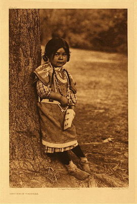 Edward S. Curtis -   Plate 270 Innocence - Umatilla - Vintage Photogravure - Portfolio, 22 x 18 inches - “Few aspects of Indian life are more interesting to the casual visitor than the demeanor of the children, with the coy bashfulness, their mischievous, sparkling eyes, their doubtful hesitating just the other side of friendship.” – Edward Curtis
<br>
<br>Edward Curtis loved the faces of children from whom he could coax an expression. Notice the native clothing and detailed beaded bag over the girl’s plaid dress and tights. Because of the time his work was recorded, many costumes showed an intermingling of the native and contemporary North American Indian lifestyles.