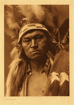 Edward S. Curtis -   Plate 272 Cayuse Warrior - Vintage Photogravure - Portfolio, 22 x 18 inches - In the face of this portrait is the pictorial description Edward Sheriff Curtis wrote in the Volume VIII. 
<br>
<br>“The Cayuse were a sullen, arrogant, warlike tribe . . . Of alien speech, they were on such intimate terms with the Shahaprian tribes of that region that even in 1851 their language was becoming obsolete, and for many years there has been none who could speak it.” 
<br>
<br>Interestingly, the tribe believed to have influenced their language, the Molala, mysteriously disappeared and were believed to have lived underground.