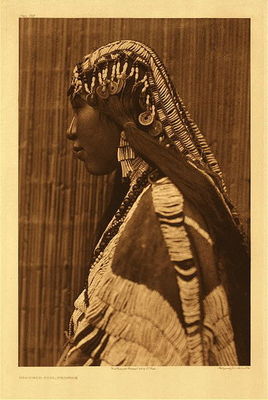 Edward S. Curtis -   Plate 279 Wishham Girl, Profile - Vintage Photogravure - Portfolio, 22 x 18 inches - Of the 723 Plates included in the Edward Curtis book The North American Indian, this is one of the rare occasions when the detail was so intricate and expansive that two views are revealed.
<br>
<br>The piercing in her nose was important to her caste. From Volume VIII of text: “Men and women wore a long dentalium shell in the nose: every one wore this nasal ornament, for anybody without it ‘looked like a slave.”