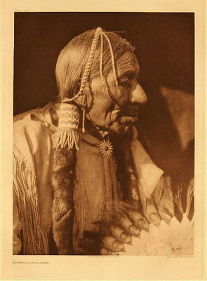 Edward S. Curtis - Plate 682 Esipermi - Comanche - Vintage Photogravure - Portfolio, 18 x 22 inches - 	"There were no more vigorous people among the Indians of the Plains than the Comanche, a Shoshonean tribe, related to the Shoshone and Bannock of Idaho, from which region they entered the Northern plains and drifted ever southward, following the bison in their wanderings. They were noted warriors and raiders, being the enemies of many tribes and extending their depredations far into Mexico. One need look no farther than the accompanying portraits to discern the warrior character of these old braves." from Edward S. Curtis' "The North American Indian", Volume XIX