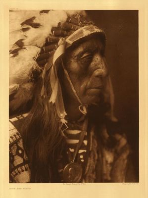 Edward S. Curtis -   Plate 081 Jack Red Cloud - Vintage Photogravure - Portfolio, 22 x 18 inches - Born 1822. The subject of this portrait is the son of the Ogalala Chief, Red Cloud. 
<br>
<br>In 1868 Red Cloud was at the height of his powers. He’d just won the most significant treaty that the Indians had ever gained with the U.S. The 1868 treaty with the Sioux gave them the Black Hills “For as long at the rivers run and the sun shall shine.” The “Bloody Bozeman” trail and three forts were closed as a result. It was 1905 when, Curtis stopped to visit Red Cloud on the Pine Ridge Indian reservation, where he’d been forced to stay for the previous 30 years. Red Cloud, had held steadfastly to his principles. He had honored the treaty with the White Men, even though they had violated every part of it within a few years of its signing.