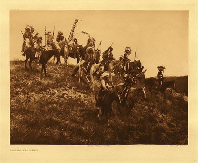 Edward S. Curtis - Plate 077 Ogalala War-Party - Vintage Photogravure - Portfolio, 18 x 22 inches - Provenance:
<br>
<br>Private Collector | Mrs. Cunningham, CA
<br>
<br>With this photogravure, was a letter written by Edward Curtis to Robert Quarles Sr. (first state archivist of Tennessee) asking if Robert thought the photos were worthy of being published in a bound version. 
<br>
<br>In the 1800s, Robert T. Quarles Sr. was a worker in the Tennessee State Capitol in Nashville.  Family lore says he was a "janitor" but that is uncertain.  At one point, the Tennessee Capitol Building experienced a flood and Quarles went to heroic lengths to save documents housed in the basement of the building.  As an expression of gratitude, Quarles was then named "Archivist" for the State of Tennessee.  Upon his retirement, Robert Quarles passed the position down to his son, Robert T. Quarles Jr. 
<br>
<br>Robert T. Quarles, Jr. took an enormous interest in Native American history and culture, and he was a member of a group called "The Loyal Order of the Red Man". Robert Quarles Jr. -- or possibly his sister Mary Ashby -- acquired one of the Curtis portfolios as a gift directly from Edward Curtis himself.  Mary and her husband, Jeff Ashby, were enthusiastic collectors of artifacts and art from all over the world.
<br>
<br>The Ashby's were childless and when they passed away, the Curtis photogravures went to the three nephews of Robert Quarles Jr. in equal parts. These works were then passed down to their descendants, who are the previous owners of this artwork.