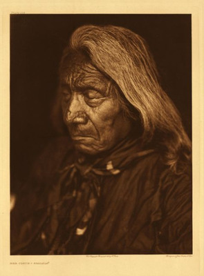 Edward S. Curtis -   Plate 103 Red Cloud - Ogalala - Vintage Photogravure - Portfolio, 21 3/8 x 17 3/16 inches - Well Known chief and celebrated warrior Red Cloud was photographed by Edward S. Curtis in 1905 when he was 83 years old. His hair has long been gray and his eyes are closed. The warrior was born in 1822 and began his life on the war path at age 15. Red Cloud became an important part of history for his absolute determination to defend his people from the “White Man”. He is well known for his defense on the Bozeman trail and is often thought to be a genius because of his expertise in war strategy. 
<br>
<br>Until the death of his father Lone man, his name had been Two Arrows. In recognition of his bravery he received the name Red Cloud from his father. He first gained notice as a leader by his success at Fort Phil. Kearny in 1866 when he killed Captain Fetterman as well as eighty soldiers. 
<br>
<br>Recently a book called “The Heart of Everything That Is” was written about Red Clouds life and battles. This photogravure is for sale at our Aspen Art Gallery.
