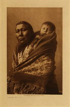 Edward S. Curtis -   Hidatsa Mother - Vintage Photogravure - Volume, 12.5 x 9.5 inches - This beautiful image photographed by Edward S. Curtis is of a Hidatsa mother with a small child strapped to her back.  When a child was born the parents made a feast and a prominent figure, likely and elderly man or woman was called upon to name the infant. There was no ceremony connected with piercing the ears a job given to the grandmother. This Edward S. Curtis photo was printed in 1908 on Dutch Van Gelder and is for sale in our Aspen Art Gallery.
<br>
<br>"The Hidatsa, commonly known under the inappropriate appellation "Gros Ventres of the Missouri," differed from most of the tribes of the northern plains in that they were a sedentary and semi-agricultural people, gaining part of their livelihood, of course, by the chase. Their habitat for many generations has been along the Missouri from heart river to the Little Missouri, in North Dakota." from Volume IV in Edward Curtis' "The North American Indian"