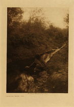 Edward S. Curtis - *50% OFF OPPORTUNITY* Maricopa Water Girl - Vintage Photogravure - Volume, 12.5 x 9.5 inches - Southern Arizona tribe Maricopa lived along the Salt River in Phoenix. The tribe was known to have made a large amount of pottery as seen here in this photogravure by Edward S. Curtis in which a young girl fetches water from a small stream. 
<br>
<br> This photogravure was taken in 1907 by Edward S. Curtis. The piece was printed on Dutch Van Gelder and is available for sale in out Aspen Art Gallery.