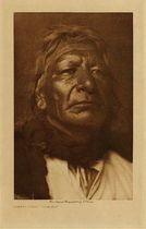 Edward S. Curtis - *50% OFF OPPORTUNITY* Stands First - Ogalala - Vintage Photogravure - Volume, 12.5 x 9.5 inches - Born about 1844. Distinguished himself as a young man by riding out alone to meet a single Apsaroke who charged from the enemy line. Stands First did not shoot, and received a wound in the breast; but as the two passed each other he struck the Apsaroke with his coup-stick, a feat of great honor. The following year-seemingly in 1869-two hundred Sioux attacked the Apsaroke camp near the fork of the Missouri, and in the thick of the fight Stands First was twice wounded in the back. In the battle of the Little Bighorn he captured the standard of the troops.
<br>
<br>Provenance: Original Subscription Set #59. George D. Barron, Rye, NY