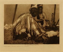 Edward S. Curtis -   Huka-Lowapi, "Work-do Removes the Covering" - Sioux - Vintage Photogravure - Volume, 9.5 x 12.5 inches - This Edward Curtis photograph is depicting a part of a ceremony called Huka-lowapi. The name of the Huka-lowapi ceremony is taken from Huka a term of respect for ones parents or ancestors, and Lowapi, they chant. The purpose of the ceremony is to implant the virtues of kindness, generosity, hospitality, truthfulness, fairness, and honesty. At the same time it is a prayer for continued prosperity, abundance of food, health, strength, and moral well-being as people. 
<br>
<br>"The name of the Hunká-lowanpi ceremony is derived from hunká, a term of respect for one's parents or ancestors, and lowanpi, they chant. As the Singer becomes the grandfather of the initiate, child or adult, a proper translation of the name seems to be Foster-parent Chant. The principal purpose of Hunká-lowanpi is to implant in the initiate the virtues of kindness, generosity, hospitality, truthfulness, fairness, honesty. At the same time it is a prayer for continued prosperity — for abundance of food, for health, strength, and moral well-being as a people.
<br>
<br>"Hunká-lowanpi is usually observed for a child who has been near to death, whose recovery is regarded as the result of the father's solemn promise to worship the Mystery by means of these rites. Having made such a vow, he begins to bend every effort to the accumulation of property— horses, skins, clothing, deerskin bags and parfléches, and many varieties of food. A sufficient quantity collected, he goes to the Hunká-lowankta, the Hunka Singer, and after the usual formal smoke announces his intention, requesting him to take charge of the ceremony.
<br>
<br>The Singer, accepting, provides the necessary sacred articles mentioned throughout the description of the rites, and on the day before the ceremony is to occur — it may be months after the intention was proclaimed — he calls to his tipi a certain man, to whom he offers the ceremonial pipe. After the smoke the man is informed that he has been selected as Wówashi-echúnkta, the Work-do, or Worker, which means that he will appear as the principal active participant in the rite. The Singer arrays him in new clothing, and the two sit in the rear of the tipi with the ceremonial paraphernalia tied into a bundle at the Singer's left.
<br>
<br>Spreading it between himself and the altar-space, Work-do calls for the buffalo-skull, which the Fire-carrier brings, wrapped in a buffalo-skin given him by the Singer, and lays tenderly on the sage. Work-do as cautiously removes the covering. He now thoroughly works a bit of red paint into a piece of buffalo-tallow, and purifies, first this mixture, then a roll of buffalo hair and a braid of sweet-grass. The hair and the sweet-grass he extends to the buffalo-skull, and after offering them to the spirits of the four quarters feigns to mark a line across its face from left temple to right, just above the orbits." -Edward S. Curtis in "The North American Indian"
<br>
<br>The photogravure was taken in 1907 by Edward Curtis and is printed on Dutch Van Gelder. The piece is available for sale in our Aspen Art Gallery.
<br>
<br>Provenance: Original Subscription Set #59. George D. Barron, Rye, NY