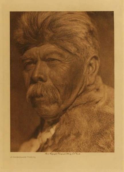 Edward S. Curtis - *50% OFF OPPORTUNITY* A Chukchansi Yokuts - Vintage Photogravure - Volume, 12.5 x 9.5 inches - Dress: men, and a great many women, more only loin cloth; other women had double aprons of shredded willow-bark, tules, or sedge, more rarely of skin. IN cold weather both sexes used robes made of strips of the skins of rabbits, coyotes, or water foul. Moccsasins were rare. Men and women drew their hair together at the back of the head and tied it in a bunch or a sheaf with a cord, or passed a head-band from the base of the cranium up over the top. In the north women generally tattooed the chin, and some men the chest and forearms; and both sexes occasionally wore a bit of bird-bone, or, rarely, a cylinder of clamshell in an orifice in the lobe of each ear and the septum of the nose. In the south, however, they did not tattoo, and ornaments were long, slender pendants of clam-shell worn about the neck, in the lobes of the ears, and the septum. - Edward Curtis