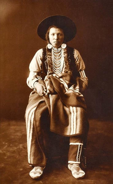 Edward S. Curtis - A Yakima - Gelatin Printing Out Print - 15 x 9 3/4 inches - Gelatin Printing out Prints <br> <br> Gelatin printing out prints (more commonly know as albumen prints) are Curtis’ earliest and scarcest master exhibition prints. This handful of exquisite prints was printed in or proximal to 1900, when Curtis made his watershed journey to the Montana Plains to witness one of the final Piegan Sundances. <br> <br>It is likely Curtis printed these images himself, in sunlight, while on that expedition. No other photographs are as close to Curtis’ own hands. It is believed there are less than 70 surviving examples of this process. Printing out Prints are the most coveted and important photographs Curtis produced. <br> <br>Following you will find noted a distinction to the albumen label. Curtis actually never printed on an albumen paper. We have termed them albumen because the medium has technically been mislabeled and we simply use "albumen" for simplicity and consistency. <br> <br>The early Curtis prints we call "albumen" are actually gelatin printing out prints. The process is exactly the same for either albumen or gelatin printing out prints. The sensitized paper was placed in direct contact with a glass negative and exposed in strong light--usually sunlight. Then, the image formed on the paper while in contact with the negative and during it's exposure to light. The final image was then toned with gold for color and permanence. <br> <br>The difference between albumen prints and gelatin printing out prints is in the papers. In both cases a thin layer of emulsion sits above the paper and contains the light-sensitive silver salts which react with light to form the image. In albumen prints, that emulsion is made from whisked egg whites, and therefore called albumen. In gelatin printing out prints, the emulsion is made from gelatin, which is a starch. Gelatin prints are more stable than albumen prints, because albumen decays very easily in the presence of moisture and light.