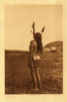 Edward S. Curtis -   Plate 083 The Sun Dancer - Vintage Photogravure - Portfolio: 22 x 18 inches - The sun dance was an important ritual in Native culture. From Edward S Curtis' Volume III: "As they dance, the performers never leave the spot on which they stand, the movement consisting in a slight upward spring from the toes and ball of the foot; legs and body are rigid. Always the right palm is extended to the yellow glaring sun, and their eyes are fixed on its lower rim. The dancer concentrates his mind, his very self, upon the one thing that he desires, whether it be the acquirement of powerful medicine or only success in the next conflict with the enemy." <br><br>In this image the Dancer is smoking a peace pipe and the detail in the photograph is so clear that one can see the smoke rising from his pipe. The subject is wearing a single feather and a simple loincloth. Much like Curtis’ description of the Sun Dance, the subject has his right palm extended towards the sky and he appears to be looking up as well.