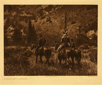 Edward S. Curtis -   Plate 136 In Black Canon - Apsaroke - Vintage Photogravure - Portfolio, 18 x 22 inches - Description by Edward Curtis: The Apsaroke, although not exclusively mountain dwellers, were ever fond of the hills, preferring the forest shade and the clear mountain streams to the hot ill-watered, monotonous prairies. The picture illustrates the Apsaroke custom of wearing at the back of the head a band from which fall numerous strands of false hair ornamented at regular intervals with pellets of bright-colored gum. Black Cañon is in the northern portion of the Bighorn Mountains, Montana.<br><br>An interesting thing to note about this image is that one of the riders is carrying a coup stick. There are 3 riders in total and they are riding away from the viewer into a mountainous area.
