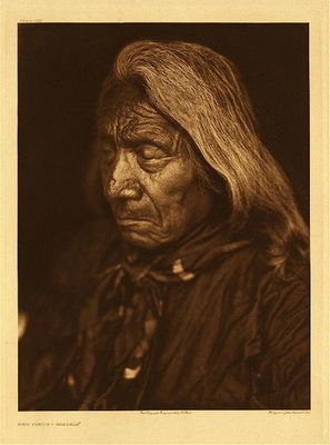 Edward S. Curtis -   Plate 103 Red Cloud - Ogalala - Vintage Photogravure - Portfolio, 22 x 18 inches - Well Known chief and celebrated warrior Red Cloud was photographed by Edward S. Curtis in 1905 when he was 83 years old. His hair has long been gray and his eyes are closed. The warrior was born in 1822 and began his life on the war path at age 15. Red Cloud became an important part of history for his absolute determination to defend his people from the “White Man”. He is well known for his defense on the Bozeman trail and is often thought to be a genius because of his expertise in war strategy. <br><br>Until the death of his father Lone man, his name had been Two Arrows. In recognition of his bravery he received the name Red Cloud from his father. He first gained notice as a leader by his success at Fort Phil. Kearny in 1866 when he killed Captain Fetterman as well as eighty soldiers. <br><br>Recently a book called “The Heart of Everything That Is” was written about Red Clouds life and battles. This photogravure is for sale at our Aspen Art Gallery.