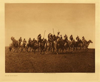 Edward S. Curtis -   Plate 085 Brule War-Party - Vintage Photogravure - Portfolio, 18 x 22 inches - Provenance: <br><br>Private Collector | Mrs. Cunningham, CA<br><br>With this photogravure, was a letter written by Edward Curtis to Robert Quarles Sr. (first state archivist of Tennessee) asking if Robert thought the photos were worthy of being published in a bound version. <br><br>In the 1800s, Robert T. Quarles Sr. was a worker in the Tennessee State Capitol in Nashville.  Family lore says he was a "janitor" but that is uncertain.  At one point, the Tennessee Capitol Building experienced a flood and Quarles went to heroic lengths to save documents housed in the basement of the building.  As an expression of gratitude, Quarles was then named "Archivist" for the State of Tennessee.  Upon his retirement, Robert Quarles passed the position down to his son, Robert T. Quarles Jr. <br><br>Robert T. Quarles, Jr. took an enormous interest in Native American history and culture, and he was a member of a group called "The Loyal Order of the Red Man". Robert Quarles Jr. -- or possibly his sister Mary Ashby -- acquired one of the Curtis portfolios as a gift directly from Edward Curtis himself.  Mary and her husband, Jeff Ashby, were enthusiastic collectors of artifacts and art from all over the world.<br><br>The Ashby's were childless and when they passed away, the Curtis photogravures went to the three nephews of Robert Quarles Jr. in equal parts. These works were then passed down to their descendants, who are the previous owners of this artwork.