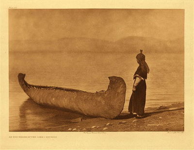 Edward S. Curtis -   Plate 251 On the Shore of the Lake - Kutenai - Vintage Photogravure - Portfolio, 18 x 22 inches - Provenance:<br><br>Private Collector | Mrs. Cunningham, CA<br><br>With this photogravure, was a letter written by Edward Curtis to Robert Quarles Sr. (first state archivist of Tennessee) asking if Robert thought the photos were worthy of being published in a bound version. <br><br>In the 1800s, Robert T. Quarles Sr. was a worker in the Tennessee State Capitol in Nashville.  Family lore says he was a "janitor" but that is uncertain.  At one point, the Tennessee Capitol Building experienced a flood and Quarles went to heroic lengths to save documents housed in the basement of the building.  As an expression of gratitude, Quarles was then named "Archivist" for the State of Tennessee.  Upon his retirement, Robert Quarles passed the position down to his son, Robert T. Quarles Jr. <br><br>Robert T. Quarles, Jr. took an enormous interest in Native American history and culture, and he was a member of a group called "The Loyal Order of the Red Man". Robert Quarles Jr. -- or possibly his sister Mary Ashby -- acquired one of the Curtis portfolios as a gift directly from Edward Curtis himself.  Mary and her husband, Jeff Ashby, were enthusiastic collectors of artifacts and art from all over the world.<br><br>The Ashby's were childless and when they passed away, the Curtis photogravures went to the three nephews of Robert Quarles Jr. in equal parts. These works were then passed down to their descendants, who are the previous owners of this artwork.