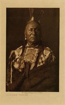 Edward S. Curtis -   Yellow Horse - Yanktonai - Vintage Photogravure - Volume, 12.5 x 9.5 inches - Yellow Horse was born in North Dakota in 1853 making him about 55 in this Edward Curtis photo. He was known to be a great warrior and his medicine was a bird-skin tied to a yellow cloth. Pictured by Curtis here in an elaborately decorated shirt and with feathers in his hair.	<br><br>This image was taken in 1908 by photographer Edward S. Curtis and was printed on Dutch Van Gelder. The original photogravure is available for sale in our Aspen Art Gallery.