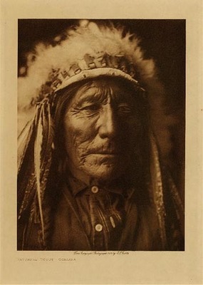 Edward S. Curtis -   Returned Scout – Ogalala - Vintage Photogravure - Volume, 12.5 x 9.5 inches - "The Teton Sioux had several other societies whose functions were much the same-that of encouraging the members to deeds of bravery and to perform acts of hospitality and liberality. Rivalry always existed between the different organizations as to which had the most aggressive and fearless leaders and the bravest men." by Edward S. Curtis in "The North American Indian," Volume III