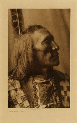 Edward S. Curtis -   Little Dog - Brule - Vintage Photogravure - Volume, 12.5 x 9.5 inches - Born 1848. First war-party at sixteen against the troops at the head of Platte river; horses were captured without fighting. The next year he led a party against a detachment on Lodgepole Creek; one soldier was killed, and some horses were taken. Counted three coups, one of the first grade, each while acting as a war-leader, and was thrice wounded. Sorrowing at the death of a sister, he went alone against the Pawnee, and nearing their camp gave chase to a solitary hunter, but abandoned the pursuit because there was no one to testify that he counted coup even if he had done so. That night he stole into camp and captured five horses. Participated in forty-one fights and fifteen horse raids. Scouted for General Crook.<br><br>Provenance: <br>Art Institute of Chicago, Ryerson & Burnham Library