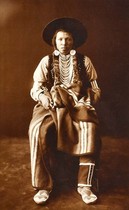 Edward S. Curtis - A Yakima - Gelatin Printing Out Print - 15 x 9 3/4 inches - Gelatin Printing out Prints 
<br>
<br> Gelatin printing out prints (more commonly know as albumen prints) are Curtis’ earliest and scarcest master exhibition prints. This handful of exquisite prints was printed in or proximal to 1900, when Curtis made his watershed journey to the Montana Plains to witness one of the final Piegan Sundances.
<br>
<br>It is likely Curtis printed these images himself, in sunlight, while on that expedition. No other photographs are as close to Curtis’ own hands. It is believed there are less than 70 surviving examples of this process. Printing out Prints are the most coveted and important photographs Curtis produced.
<br>
<br>Following you will find noted a distinction to the albumen label.  Curtis actually never printed on an albumen paper. We have termed them albumen because the medium has technically been mislabeled and we simply use "albumen" for simplicity and consistency.  
<br> 
<br>The early Curtis prints we call "albumen" are actually gelatin printing out prints. The process is exactly the same for either albumen or gelatin printing out prints. The sensitized paper was placed in direct contact with a glass negative and exposed in strong light--usually sunlight. Then, the image formed on the paper while in contact with the negative and during it's exposure to light. The final image was then toned with gold for color and permanence.
<br> 
<br>The difference between albumen prints and gelatin printing out prints is in the papers. In both cases a thin layer of emulsion sits above the paper and contains the light-sensitive silver salts which react with light to form the image. In albumen prints, that emulsion is made from whisked egg whites, and therefore called albumen. In gelatin printing out prints, the emulsion is made from gelatin, which is a starch.  Gelatin prints are more stable than albumen prints, because albumen decays very easily in the presence of moisture and light.